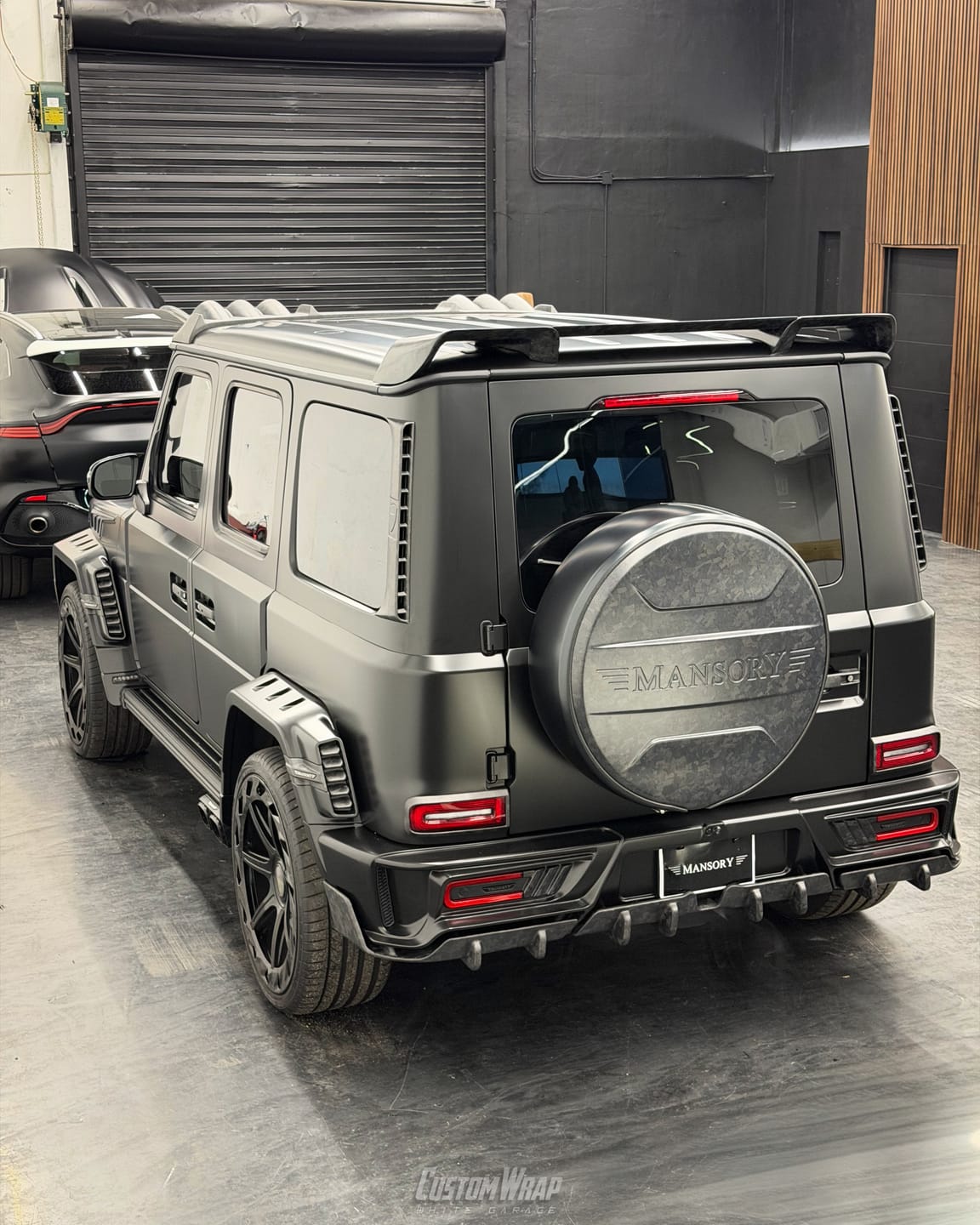 Mercedes-Benz G-Class Mansory in a full Satin Black wrap, rear three quarter view