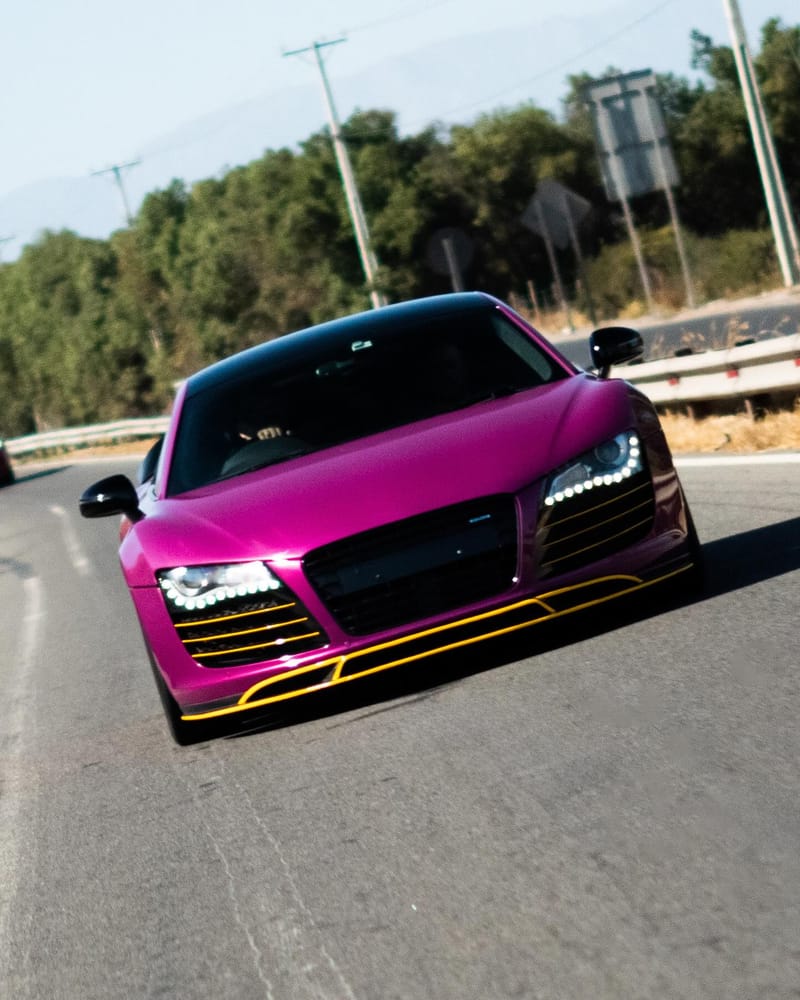 Audi R8 wrapped in Berry Purple with yellow details, on the road
