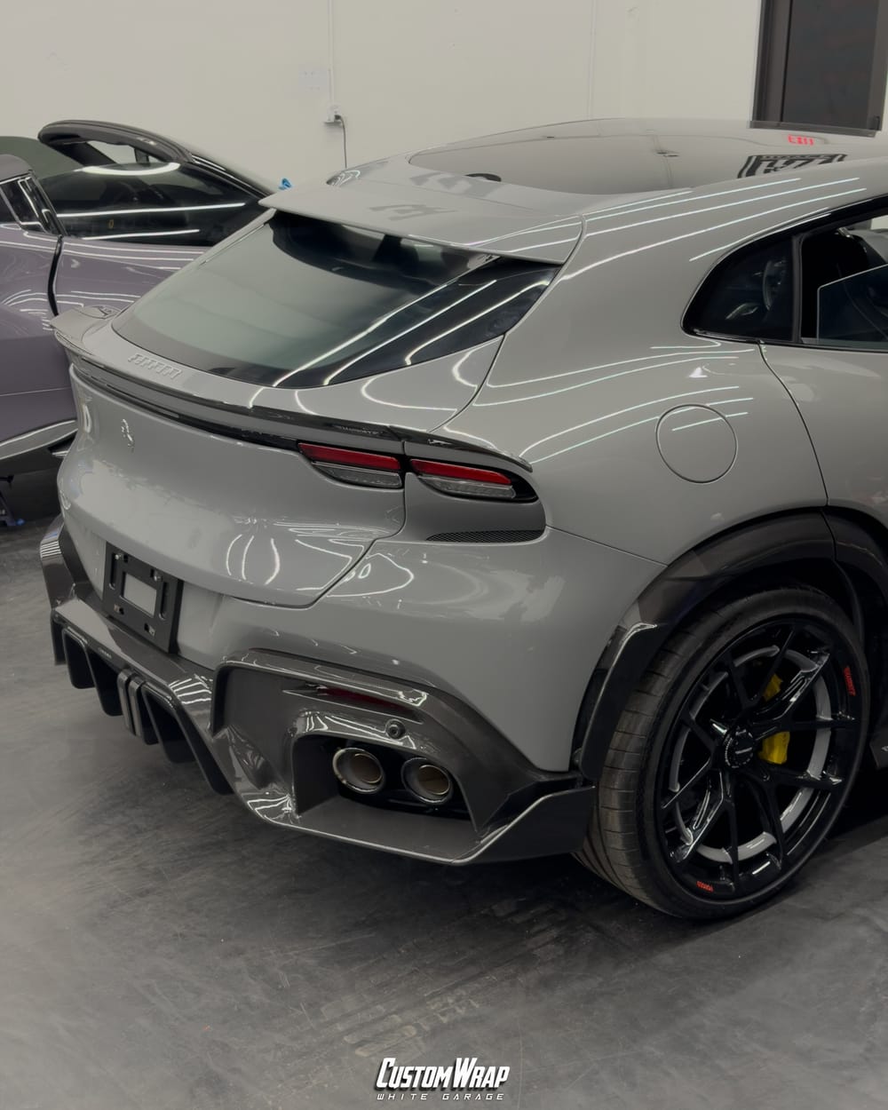 Rear of the Ferrari Purosangue Mansory after its wrap from red to Nardo Gray